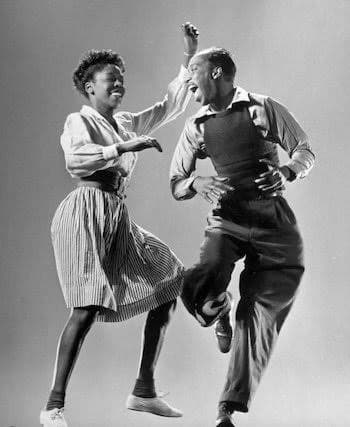 Leon James and Willa Mae Ricker dancing mid-step in a studio