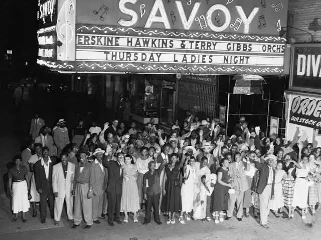 A crowd gathered under the marquee outside the Savoy Ballroom in Harlem